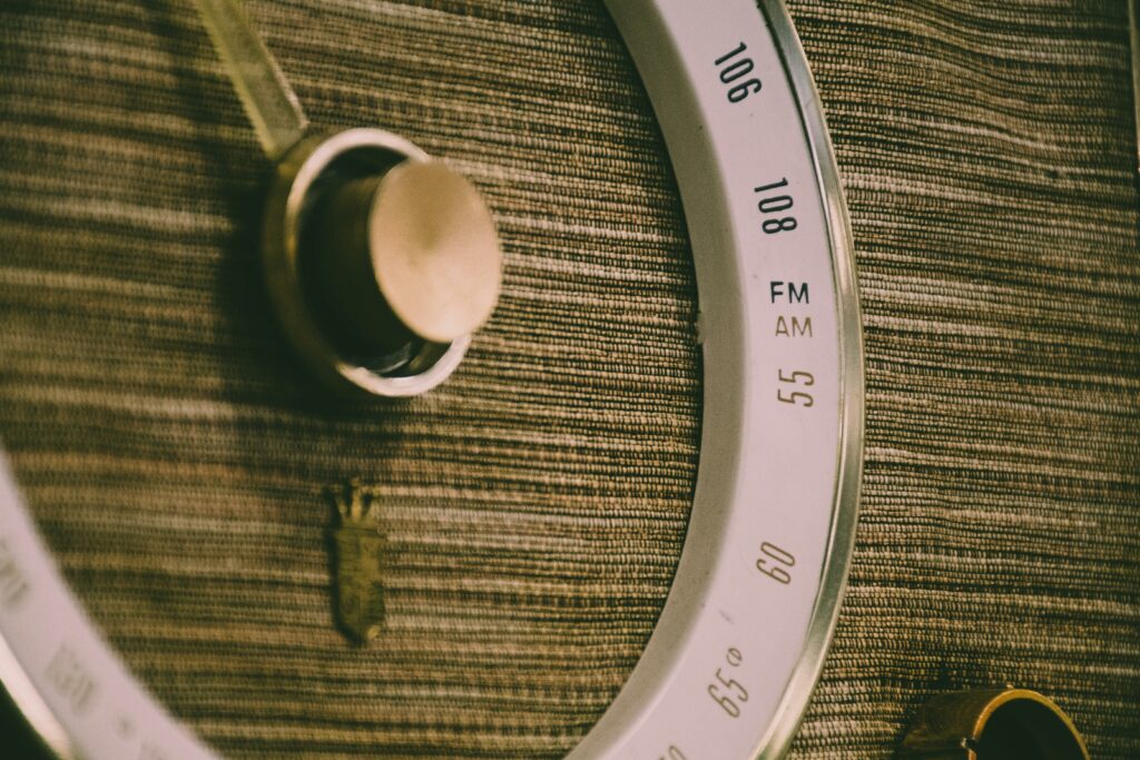 Detailed close-up of an antique radio's tuning dial, showcasing its retro design.