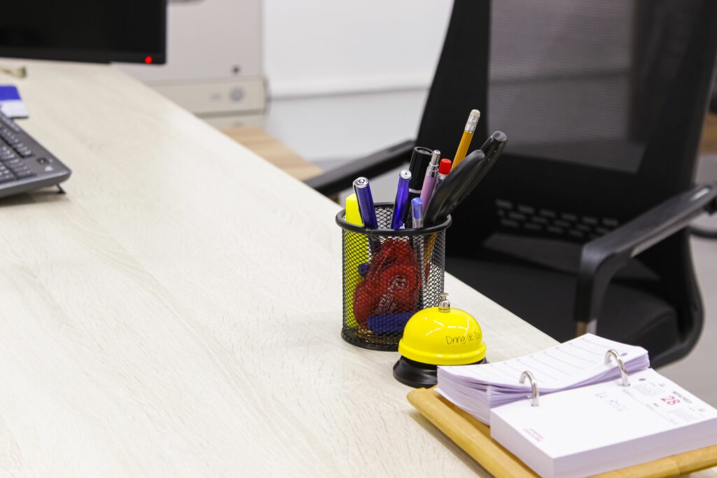 Tidy office desk with pen holder and clipboard, creating a clean workspace.